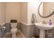 Powder room with a pedestal sink, toilet and gray trim at 9820 Janeiro Dr, Huntersville, NC 28078