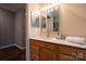 Well-lit bathroom with wood-look flooring, bright countertops and a modern mirror at 9820 Janeiro Dr, Huntersville, NC 28078