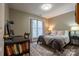 Comfortable bedroom with a cozy rug, a large window, and a workspace with desk and shelving at 9820 Janeiro Dr, Huntersville, NC 28078