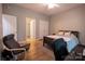 Comfortable bedroom features a bed, sitting chair, and ensuite bathroom and closet at 9820 Janeiro Dr, Huntersville, NC 28078