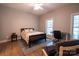 Bright bedroom featuring a comfortable bed, desk, and windows offering natural light at 9820 Janeiro Dr, Huntersville, NC 28078