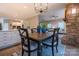 Eat-in kitchen featuring a wood table, blue area rug and views to living room with stone fireplace at 9820 Janeiro Dr, Huntersville, NC 28078