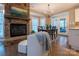 Dining area with stone fireplace, wood floors, a modern chandelier and lots of natural light at 9820 Janeiro Dr, Huntersville, NC 28078
