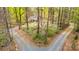 Secluded home nestled amongst the trees with a long driveway leading to the residence at 9820 Janeiro Dr, Huntersville, NC 28078