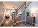 Home foyer with staircase and view of the living room that features a large brick fireplace at 9820 Janeiro Dr, Huntersville, NC 28078