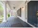 Welcoming front porch with rocking chairs, a ceiling fan, and a dark blue entrance door at 9820 Janeiro Dr, Huntersville, NC 28078