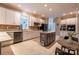 Bright kitchen with white cabinets, stainless steel appliances, tile backsplash, and a gray island at 9820 Janeiro Dr, Huntersville, NC 28078