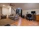 Spacious living area with hardwood floors, neutral walls, a ceiling fan, and bright windows at 9820 Janeiro Dr, Huntersville, NC 28078