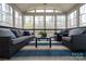 Inviting sunroom with lots of light, wicker furniture, blue accents and a wood deck at 9820 Janeiro Dr, Huntersville, NC 28078
