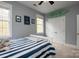 Bright bedroom with light-blue walls, two windows, double door closet and a bed with blue and white striped bedding at 11308 Wheat Ridge Rd, Charlotte, NC 28277