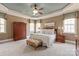 Spacious bedroom features tray ceiling, ceiling fan, carpet floors, and large window for plenty of natural light at 11308 Wheat Ridge Rd, Charlotte, NC 28277