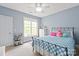 Bedroom featuring blue accent walls, a black iron bed frame, and carpet flooring for comfort and style at 11308 Wheat Ridge Rd, Charlotte, NC 28277
