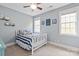 Charming bedroom with light-blue walls, two windows, and a bed with blue and white striped bedding at 11308 Wheat Ridge Rd, Charlotte, NC 28277
