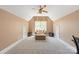Bright bonus room with neutral carpet, ceiling fan, and sitting area by a large window for plenty of natural light at 11308 Wheat Ridge Rd, Charlotte, NC 28277