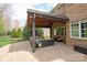 Covered patio boasts a beautiful brick floor, wood ceiling with fan and plush outdoor seating at 11308 Wheat Ridge Rd, Charlotte, NC 28277