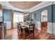 Inviting dining room with wainscoting, hardwood floors, and modern light fixture at 11308 Wheat Ridge Rd, Charlotte, NC 28277