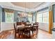 Inviting dining room with hardwood floors, a modern light fixture, and a large window at 11308 Wheat Ridge Rd, Charlotte, NC 28277