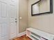 Inviting entryway with storage bench and a classic white door at 11308 Wheat Ridge Rd, Charlotte, NC 28277