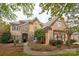 Charming two-story home with a combination of brick, stone, and stucco facade, and well-manicured landscaping at 11308 Wheat Ridge Rd, Charlotte, NC 28277
