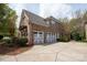 Spacious three-car garage with ample driveway space, side entry door, and mature landscaping at 11308 Wheat Ridge Rd, Charlotte, NC 28277