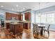 Bright kitchen featuring wood cabinets, an island, a cozy breakfast nook, and plenty of natural light at 11308 Wheat Ridge Rd, Charlotte, NC 28277