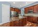Spacious kitchen with island, stainless steel appliances, and rich wood cabinetry at 11308 Wheat Ridge Rd, Charlotte, NC 28277