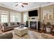 Cozy living room with fireplace, ceiling fan, and plush furniture, perfect for relaxation at 11308 Wheat Ridge Rd, Charlotte, NC 28277