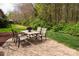 Backyard features an outdoor dining set on a patio that is great for entertaining at 11308 Wheat Ridge Rd, Charlotte, NC 28277