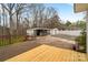 A wooden deck overlooks the backyard with a pool, shed, and outdoor kitchen, perfect for entertainment at 1197 Fincher Rd, Fort Lawn, SC 29714
