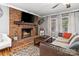 Cozy living room with a large brick fireplace and a comfortable sofa at 1197 Fincher Rd, Fort Lawn, SC 29714
