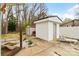 Exterior view of a well-maintained white storage shed with a door, complemented by a lounge chair at 1197 Fincher Rd, Fort Lawn, SC 29714