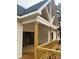 Inviting exterior with wooden porch, white siding, and distinctive architectural detail at 1204 Sage Pine Cir, Clover, SC 29710