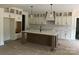 Spacious kitchen with a large island, custom cabinetry, and modern lighting fixtures at 1204 Sage Pine Cir, Clover, SC 29710