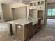 Kitchen island featuring a farmhouse sink, countertop, and storage at 1204 Sage Pine Cir, Clover, SC 29710