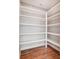 A large closet with wooden floors and white shelves at 1204 Sage Pine Cir, York, SC 29710