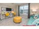 Stylish bonus room featuring yellow chairs, a turquoise sofa, and bright natural light at 122 Fordingbridge Ln, Mooresville, NC 28115