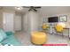 Spacious bonus room with a turquoise sofa, yellow chairs, and ample natural light at 122 Fordingbridge Ln, Mooresville, NC 28115
