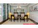 Elegant dining room with tray ceilings, modern chandelier, and large windows with decorative drapes at 122 Fordingbridge Ln, Mooresville, NC 28115