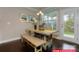 Eat-in kitchen features a long wooden table with bench seating and a door to the outdoor living space at 122 Fordingbridge Ln, Mooresville, NC 28115