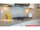 Modern kitchen features gray subway tile backsplash, granite countertops, gas cooktop, and white cabinets at 122 Fordingbridge Ln, Mooresville, NC 28115