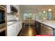 Open kitchen with a granite island, stainless steel appliances, and a view into the adjacent dining area at 122 Fordingbridge Ln, Mooresville, NC 28115