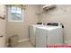 Well-lit laundry room equipped with modern white washer and dryer units at 122 Fordingbridge Ln, Mooresville, NC 28115