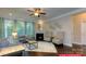 Cozy living room with fireplace, ceiling fan, hardwood floors, large windows with curtains, and neutral decor at 122 Fordingbridge Ln, Mooresville, NC 28115