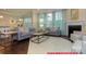 Open concept living room features hardwood floors, fireplace, kitchen with island, and dining area at 122 Fordingbridge Ln, Mooresville, NC 28115