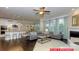 Open concept living room features hardwood floors, fireplace, kitchen with island, and dining area at 122 Fordingbridge Ln, Mooresville, NC 28115