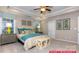 Comfortable main bedroom with decorative pillows, tray ceiling, and bright natural light at 122 Fordingbridge Ln, Mooresville, NC 28115