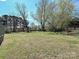 This expansive backyard features a chain link fence and mature trees providing plenty of shade at 12300 Eva St, Matthews, NC 28105