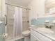 This bathroom features tile flooring, baby-blue tile, marble countertop vanity, and a shower/tub combo at 12300 Eva St, Matthews, NC 28105