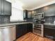 Modern kitchen featuring stainless steel appliances, sleek black cabinets, and granite countertops for functionality at 12300 Eva St, Matthews, NC 28105
