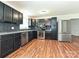 Modern kitchen with stainless steel appliances, black cabinets, granite countertops, and stylish backsplash at 12300 Eva St, Matthews, NC 28105